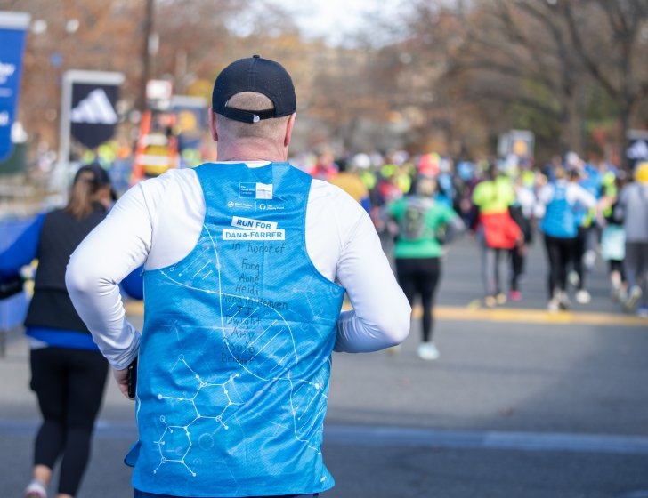 Runner on a race course in a Dana-Farber singlet