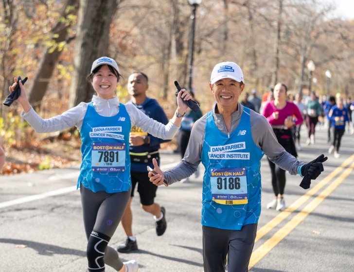 Two runners celebrating on a race course