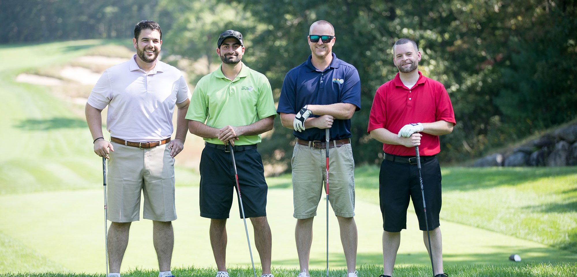 Four golfers on a golf course