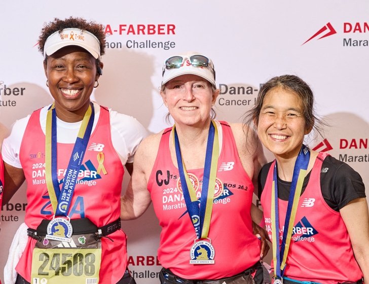 Four Dana-Farber Marathon Challenge runners with their medals
