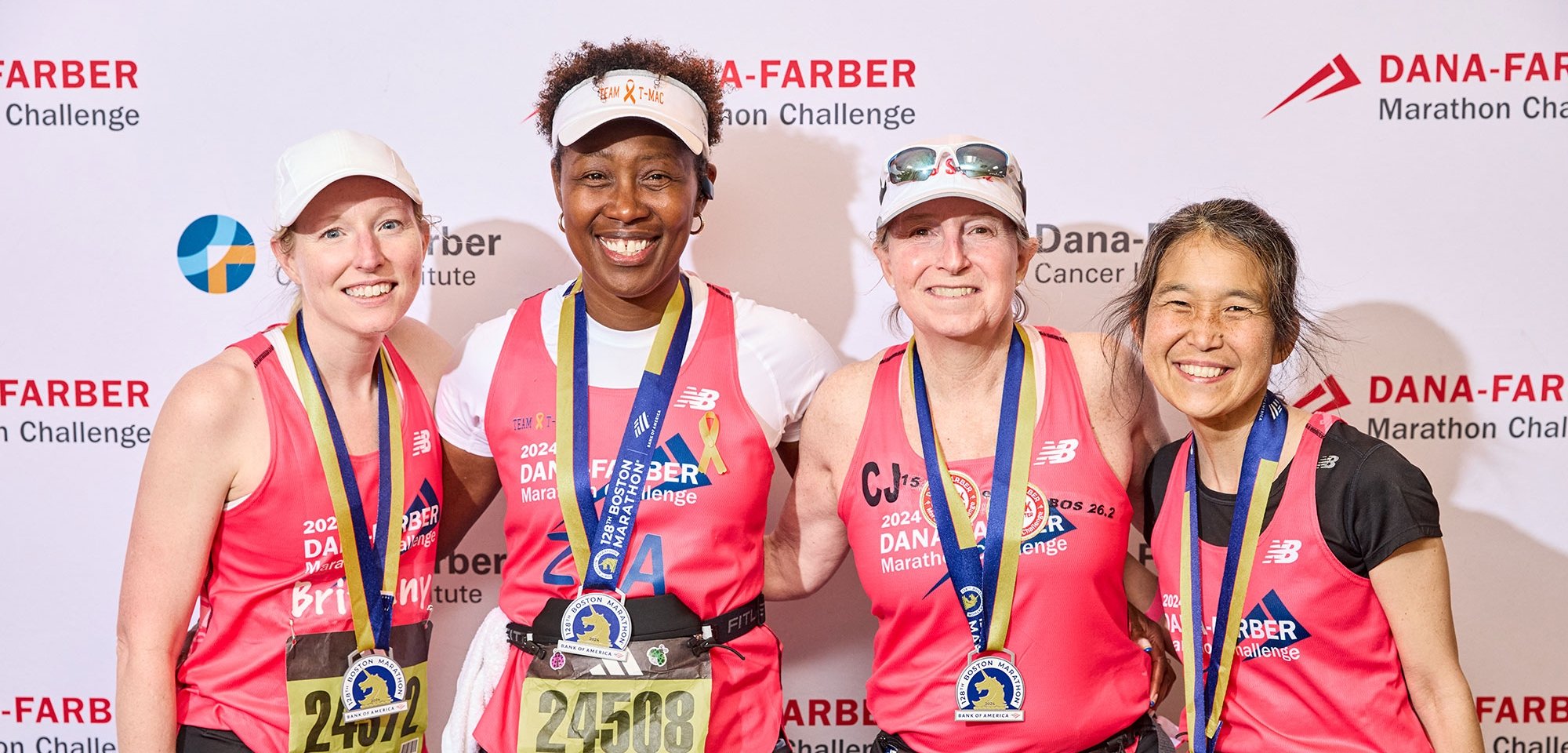 Four Dana-Farber Marathon Challenge runners with their medals
