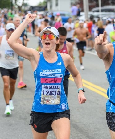 Two runners cheering on the course at the Falmouth Road Race