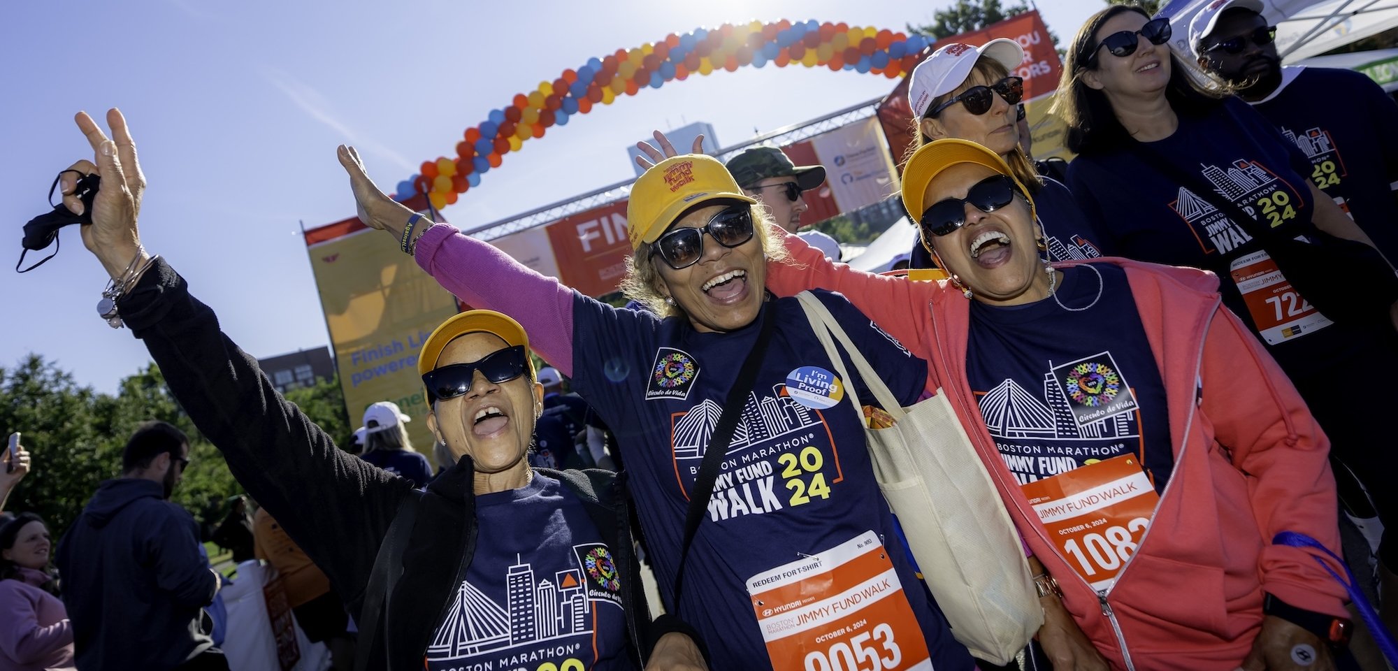 Three Jimmy Fund Walk participants cheering at the finish line