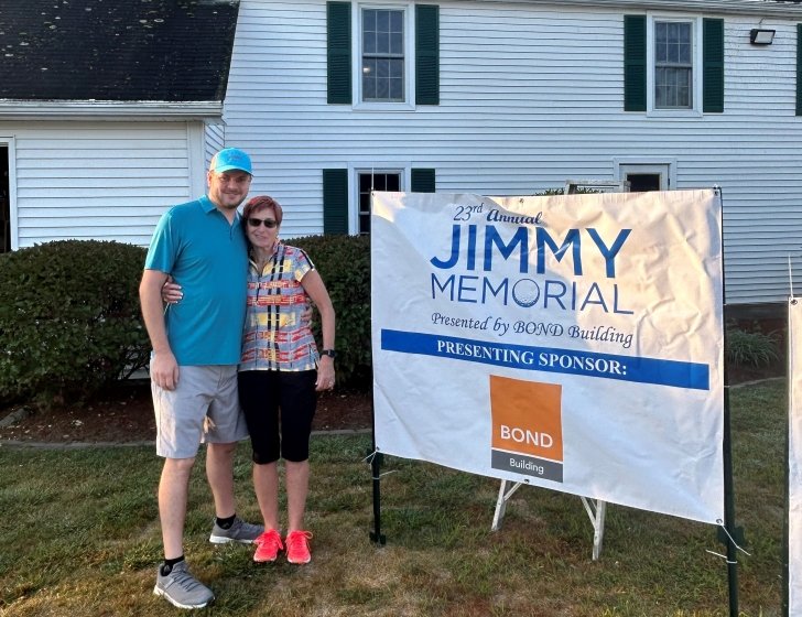Two people next to a Jimmy Memorial sign