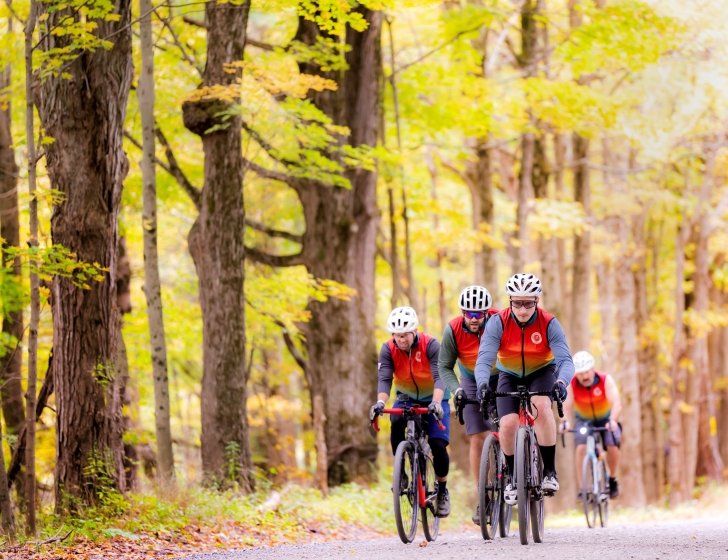Group of riders biking in the woods with the PMC Unpaved