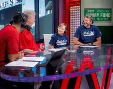 A Dana-Farber pediatric patient speaks with broadcasters at the WEEI/NESN Jimmy Fund Radio-Telethon