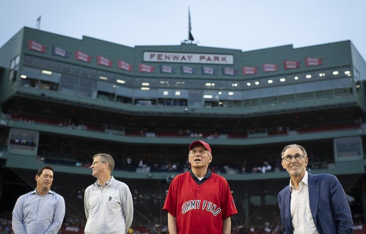 Former Chairman Larry Lucchino in a Jimmy Fund shirt with others at Fenway Park