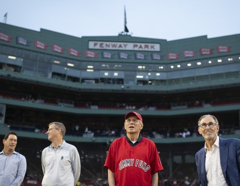 Former Chairman Larry Lucchino in a Jimmy Fund shirt with others at Fenway Park