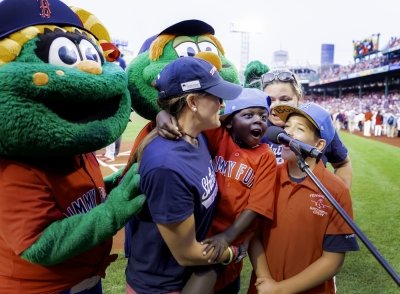 Young Dana-Farber patient with his mothers and Wally and Tessie at Fenway Park