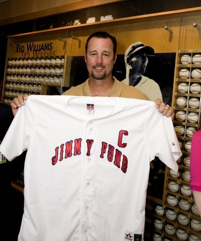 Tim Wakefield holding a Jimmy Fund jersey