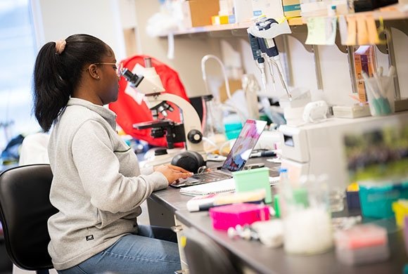 Dana-Farber staff member working at a lab bench