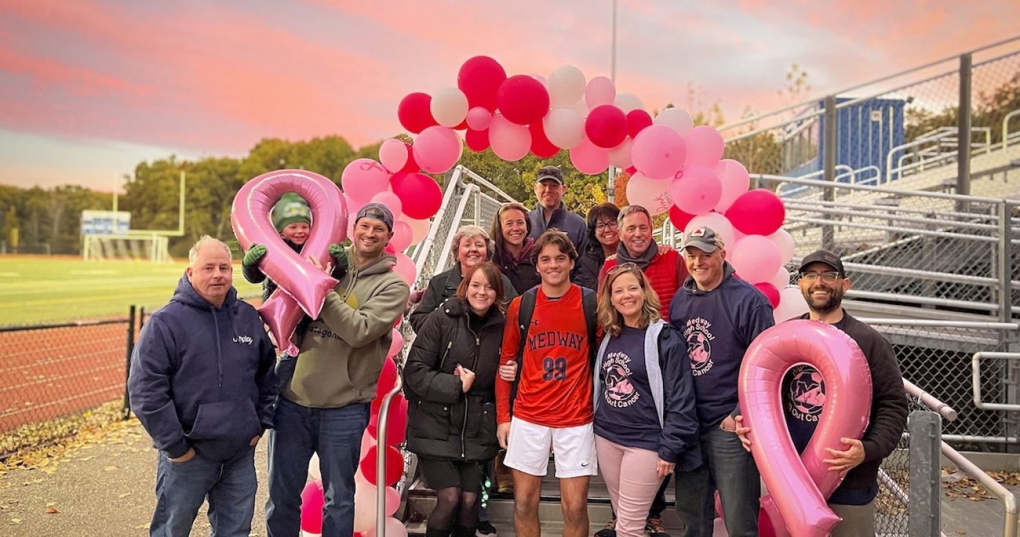 A group of Jimmy FundRaisers near a soccer field with pink balloons