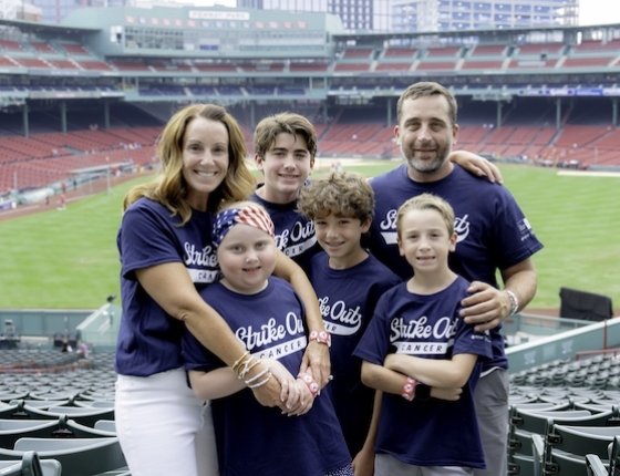 A family wearing Strike Out Cancer T-shirts at Fenway Park