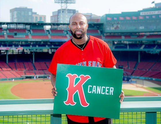 Man holds K Cancer sign at Fenway Park