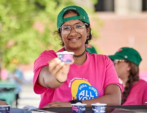 Scooper Bowl volunteer handing out a dish of ice cream
