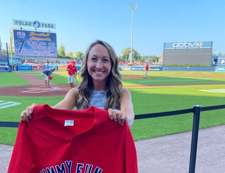 Amber holding a Jimmy Fund jersey in Polar Park