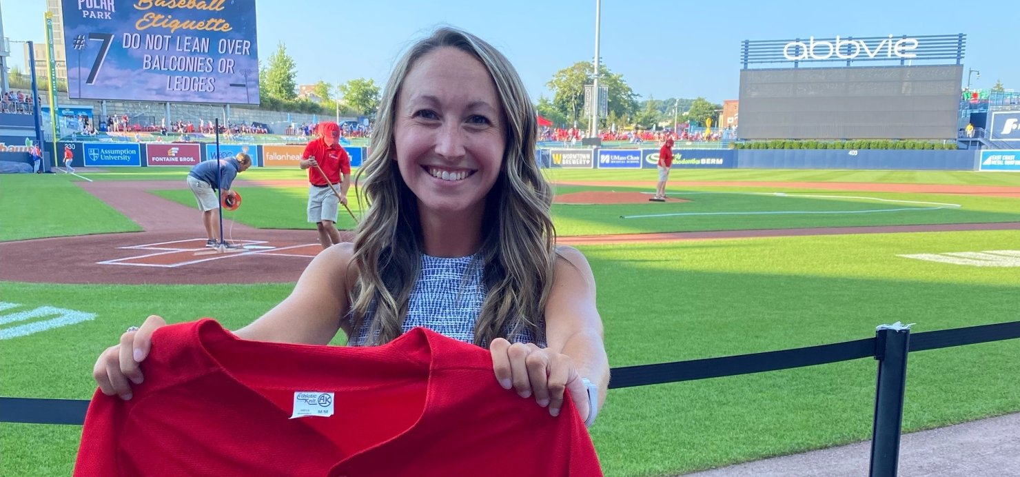 Amber holding a Jimmy Fund jersey in Polar Park