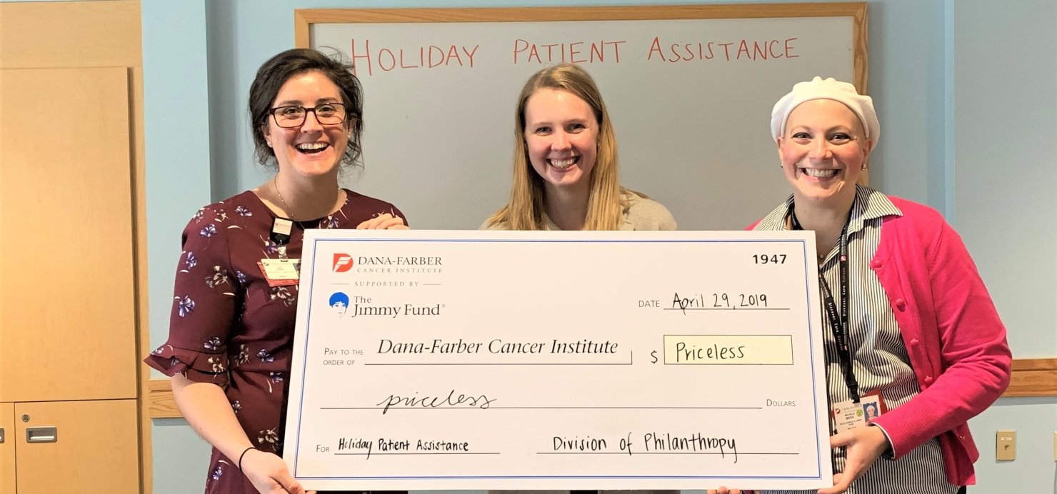 Casey, Hannah, and Michela holding a large check