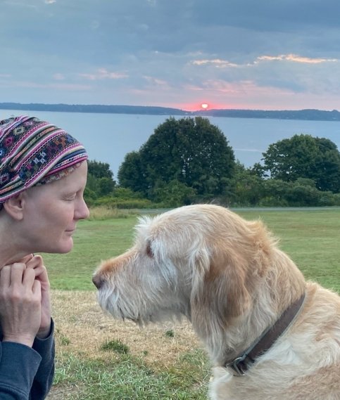 Patsy and her dog outside at sunset