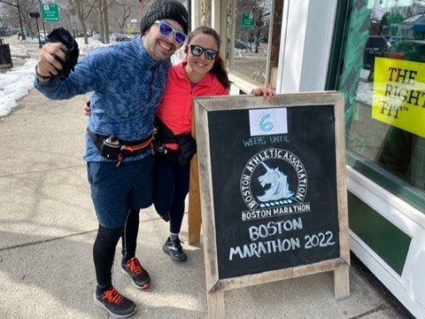 Alfonso and Stephany by a Boston Marathon chalkboard sign