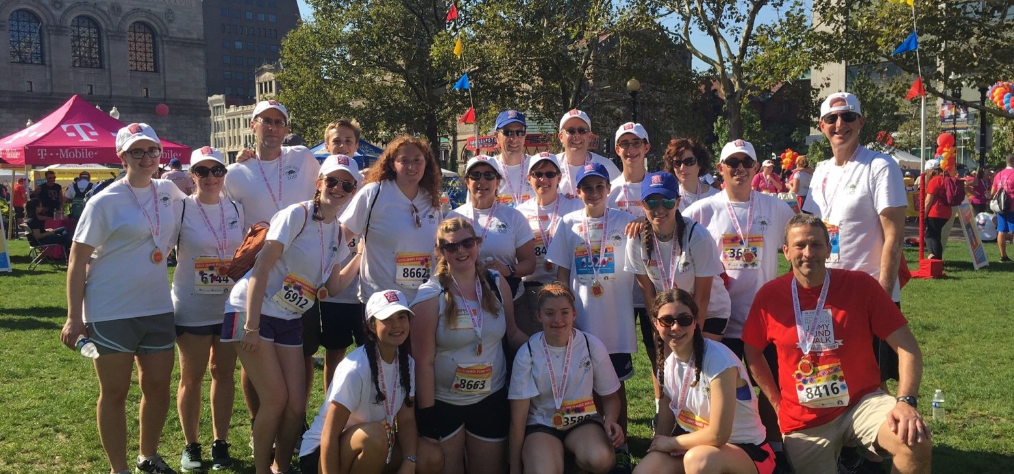 20-member Jimmy Fund Walk team stands together on lawn in Copley Plaza, Boston