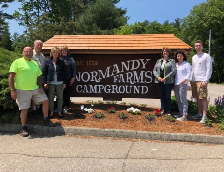 The Daniels family at a Normandy Farms Campground sign