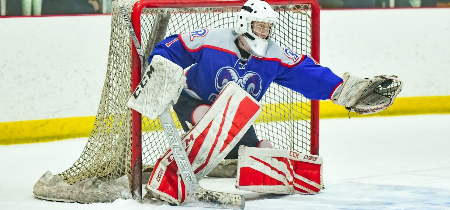 Ice hockey goalie catching a puck