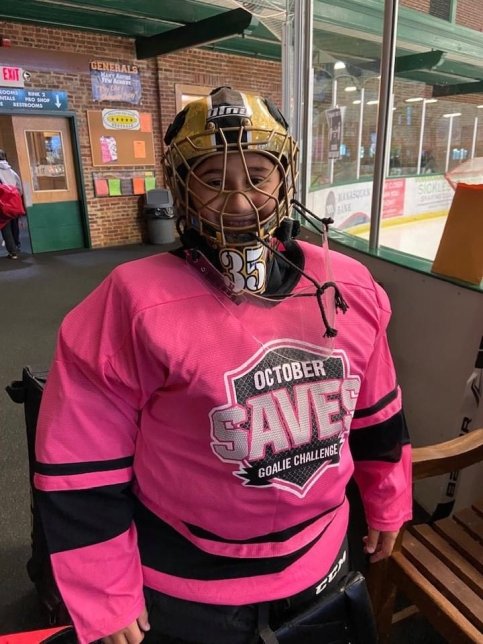 Hockey player wearing an 'October Saves Goalie Challenge' shirt
