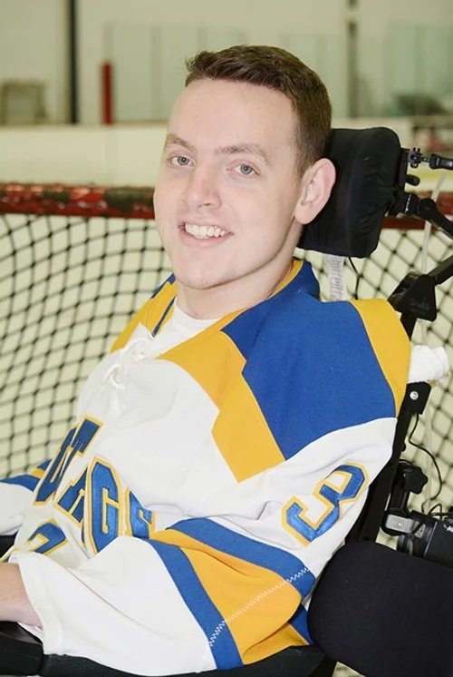 Matt in a hockey jersey at an ice rink