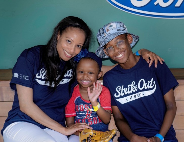 Family sits in Fenway Park dugout wearing 'Strike Out Cancer' T-shirts