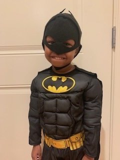 Samara smiles wearing her batman costume