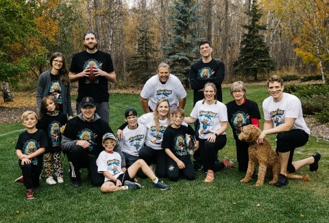 Scragg family takes a break outside during a game of football