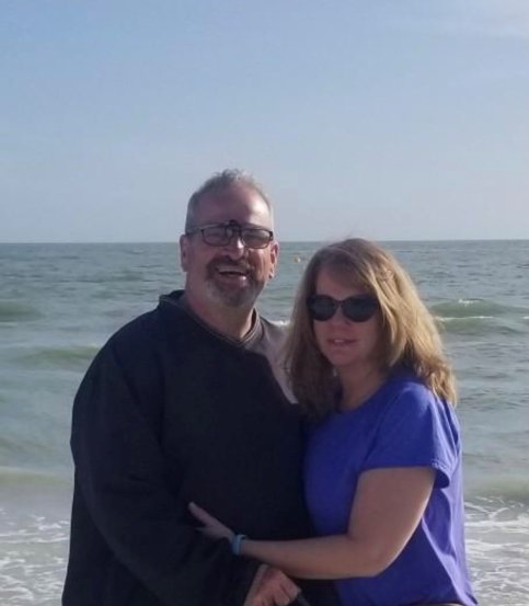 Steve with his wife on the beach