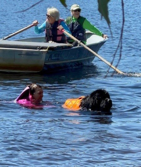 People and a dog in water