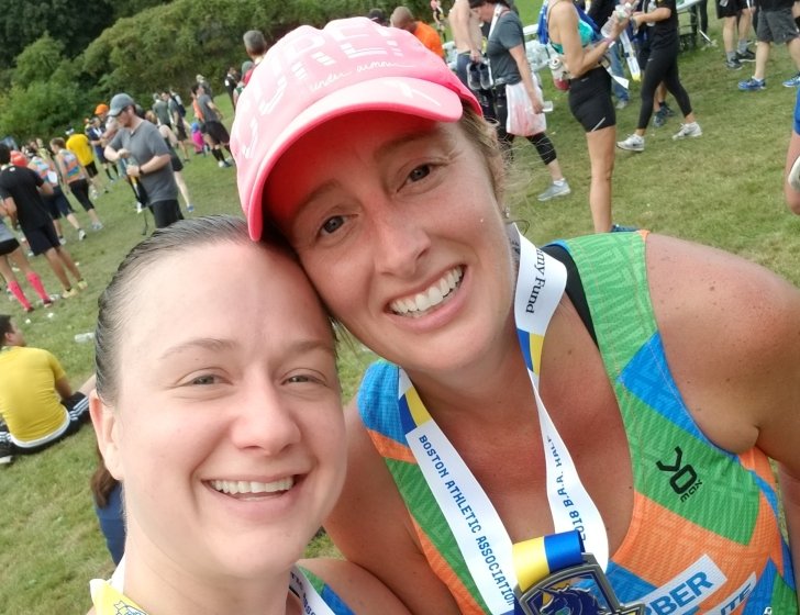 Sarah stands with teammate at the B.A.A. Half