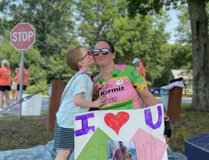 Declan kisses his mother’s cheek as she prepares for a race