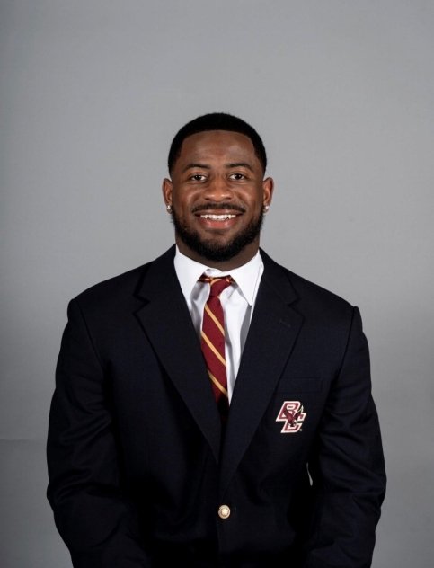 Bryce wearing suit with BC logo
