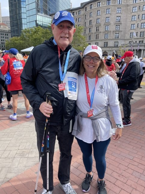 Two walkers stand in Copley square wearing Jimmy Fund Walk medals
