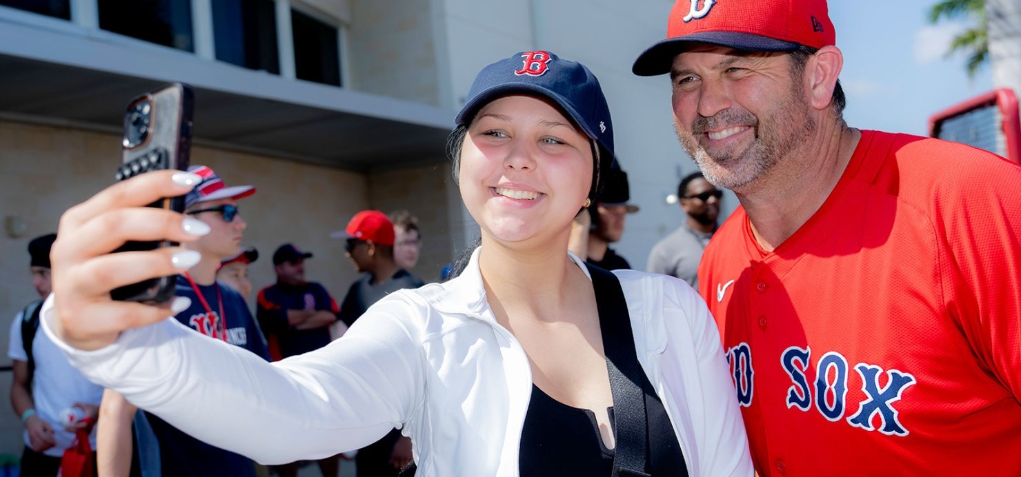 Two people in Red Sox gear take a selfie