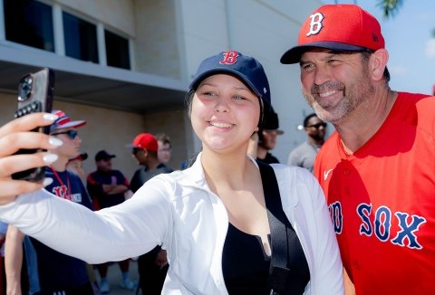 Two people in Red Sox gear take a selfie