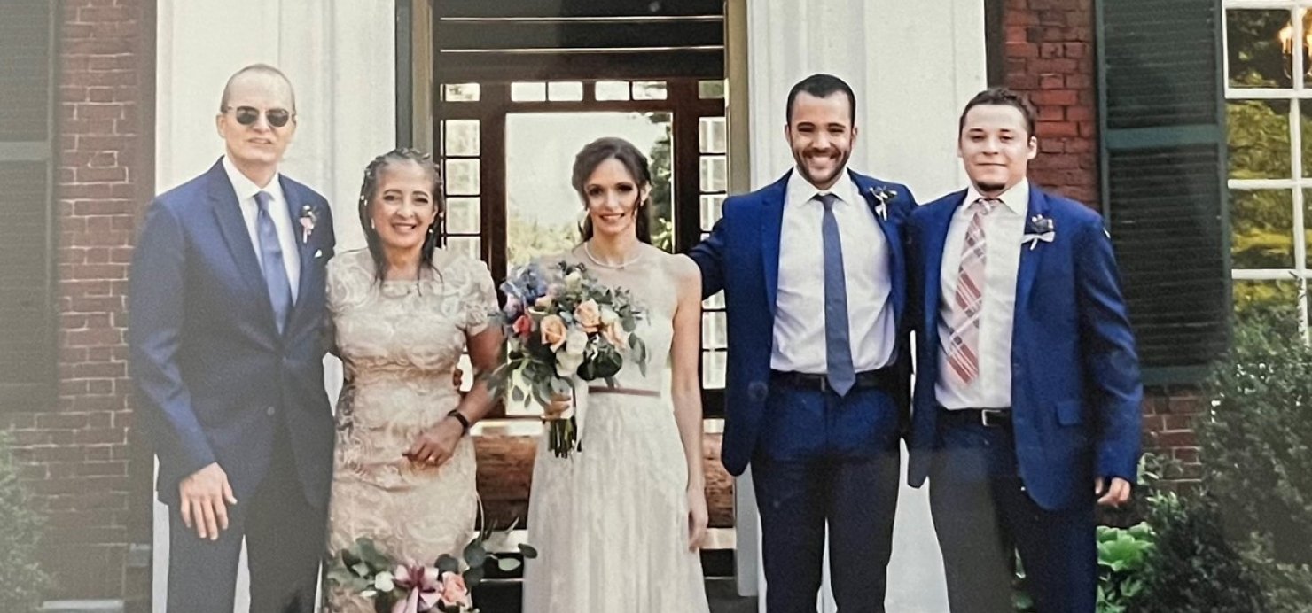 Patti stands with family dressed for wedding