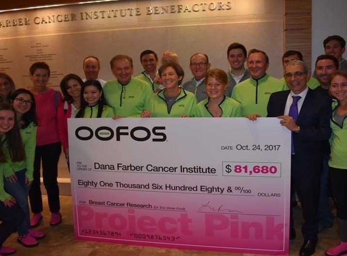 OOFOS staff during a check presentation celebration