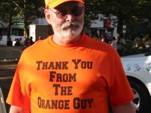The Orange Guy wearing an orange T-shirt that says ‘Thank you from the Orange Guy’