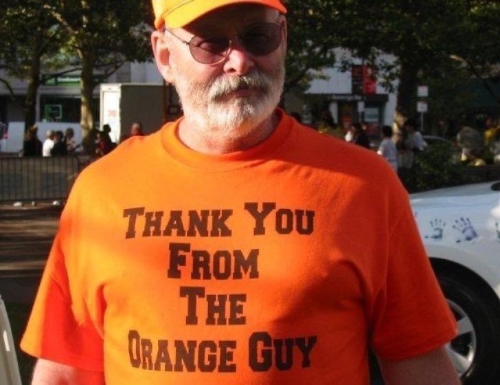 The Orange Guy wearing an orange T-shirt that says ‘Thank you from the Orange Guy’