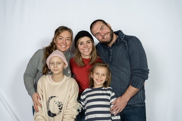 Beth poses with Sasha and her family