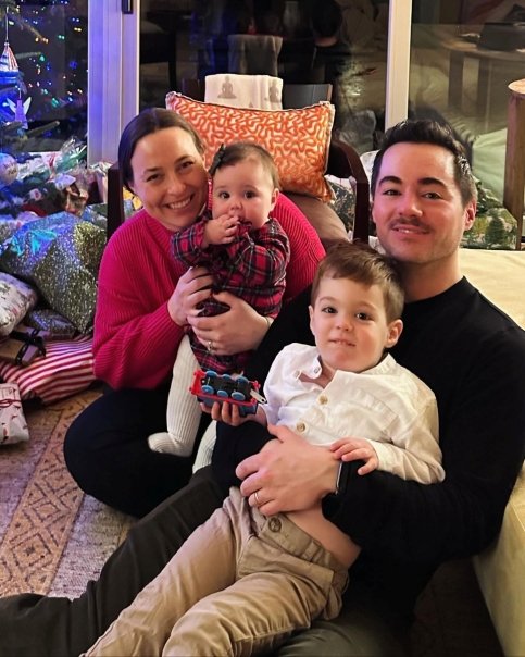 Stephanie and her family by a Christmas tree