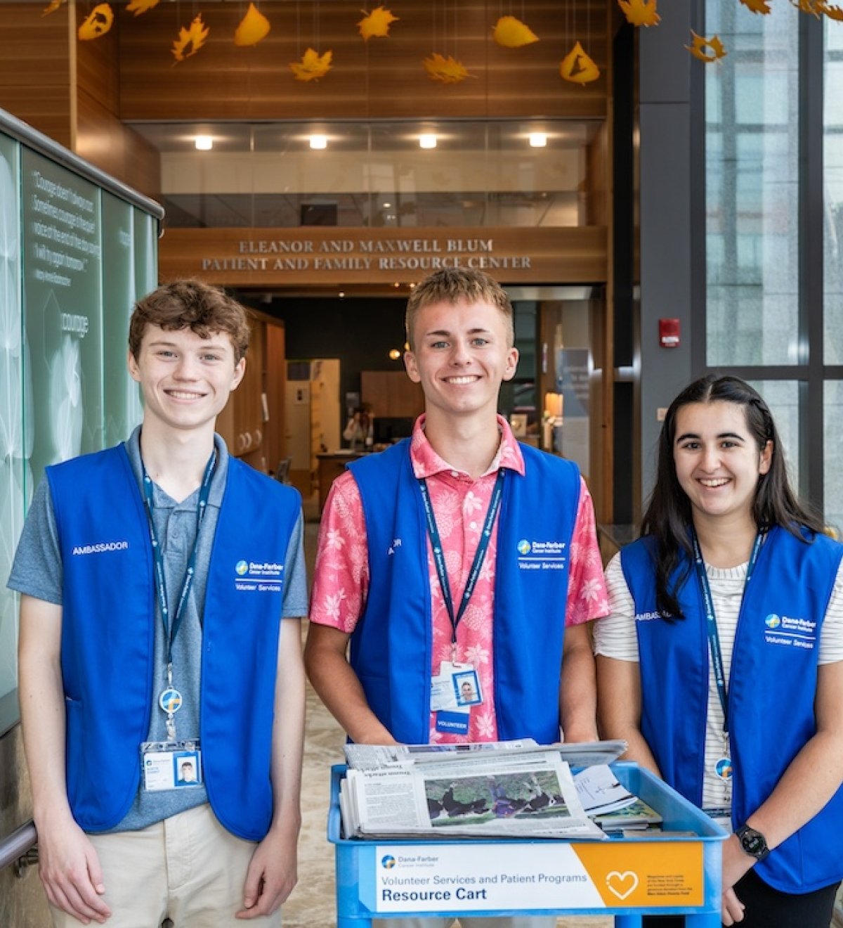 A group of volunteers distributes newspapers to patients