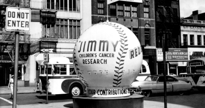 A black and white photo of a giant baseball display from the 1950s for the Jimmy Fund