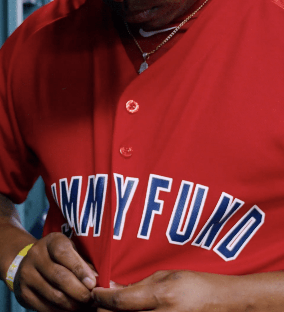 Baseball player buttons Jimmy Fund jersey